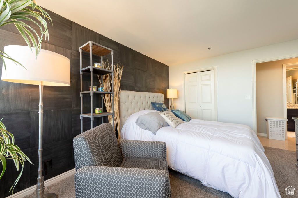 Carpeted bedroom with a closet and baseboards