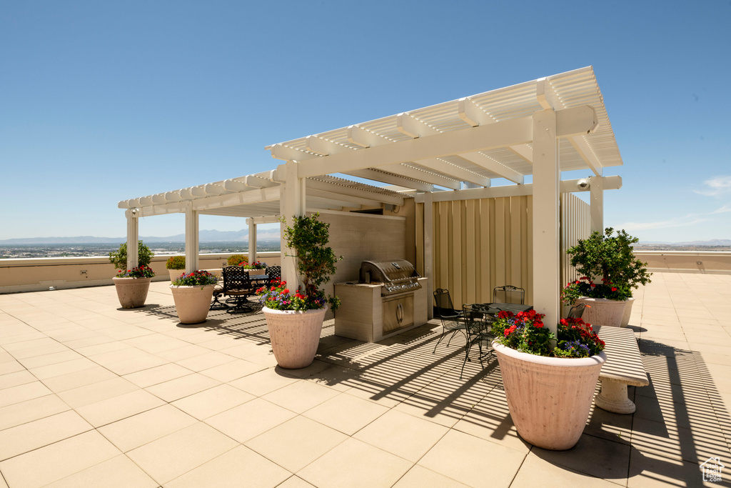 View of patio / terrace featuring a pergola and an outdoor kitchen