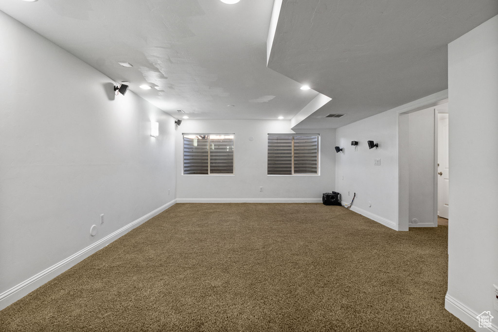 Carpeted spare room with baseboards