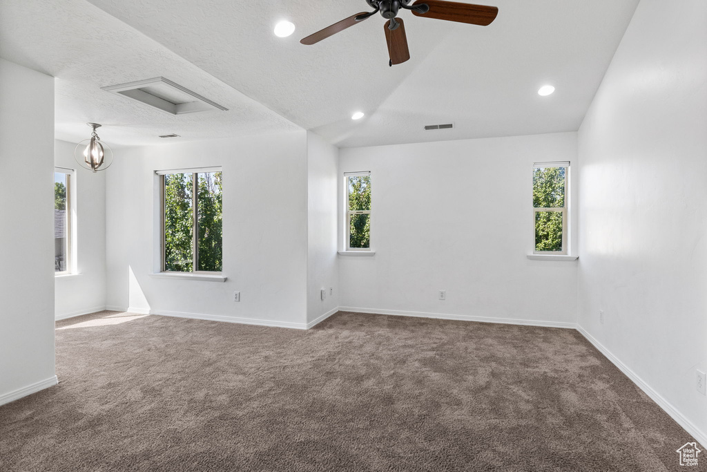 Unfurnished room featuring carpet floors, healthy amount of natural light, ceiling fan, and recessed lighting