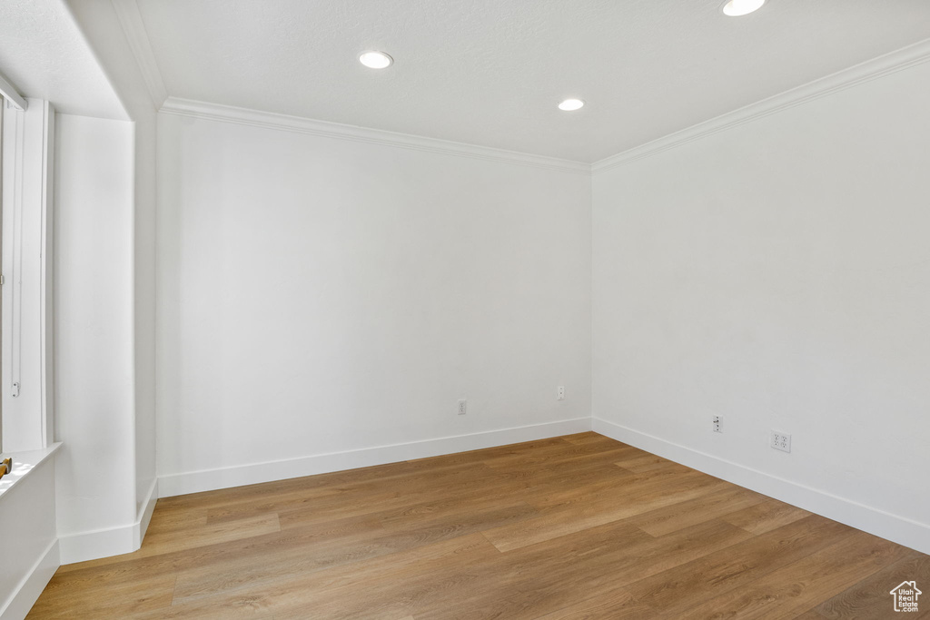 Unfurnished room featuring crown molding, recessed lighting, and light wood-style flooring