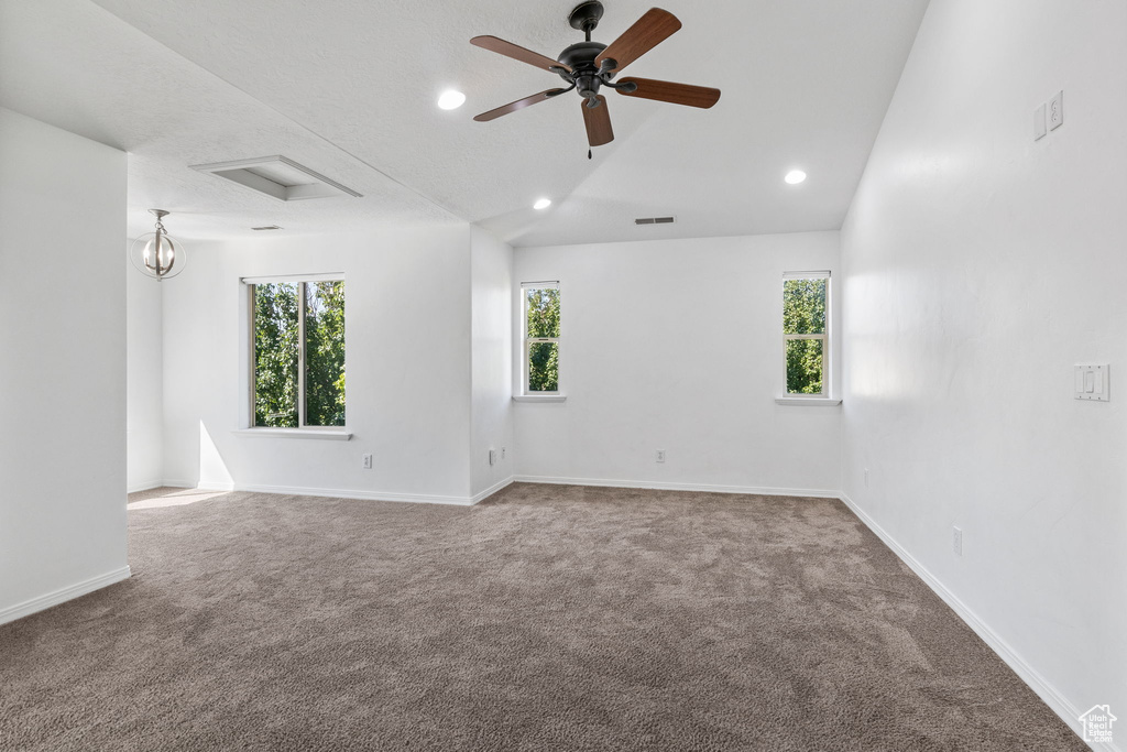 Spare room featuring carpet, attic access, a ceiling fan, recessed lighting, and lofted ceiling