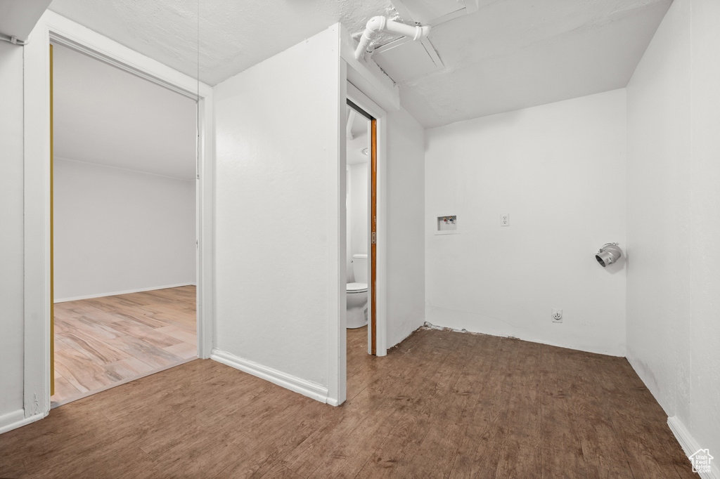 Laundry area with wood finished floors