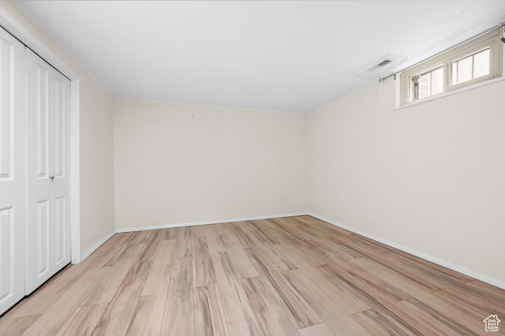 Unfurnished bedroom with light wood-style flooring and a closet