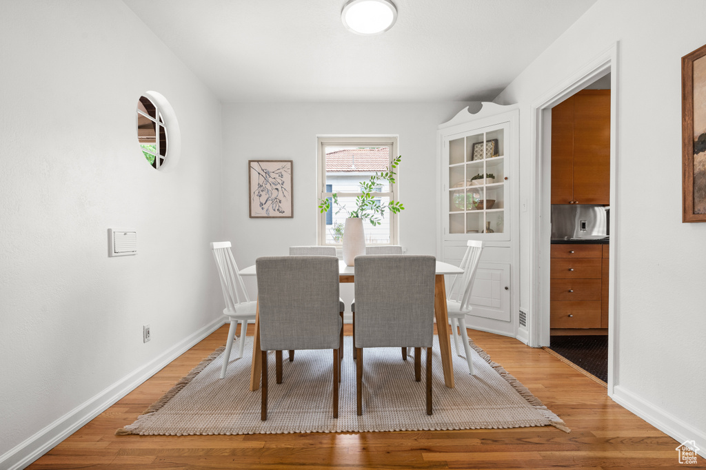 Dining space with light wood finished floors and baseboards