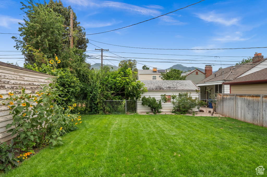 Fenced backyard with an outdoor structure