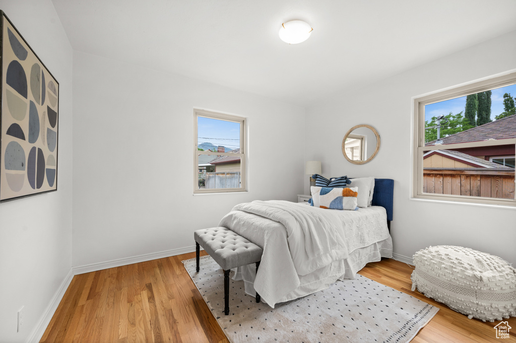 Bedroom featuring multiple windows and wood finished floors