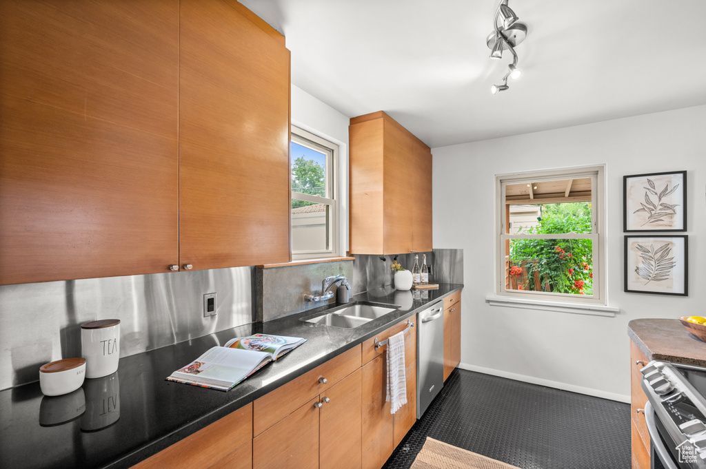Kitchen featuring appliances with stainless steel finishes and backsplash