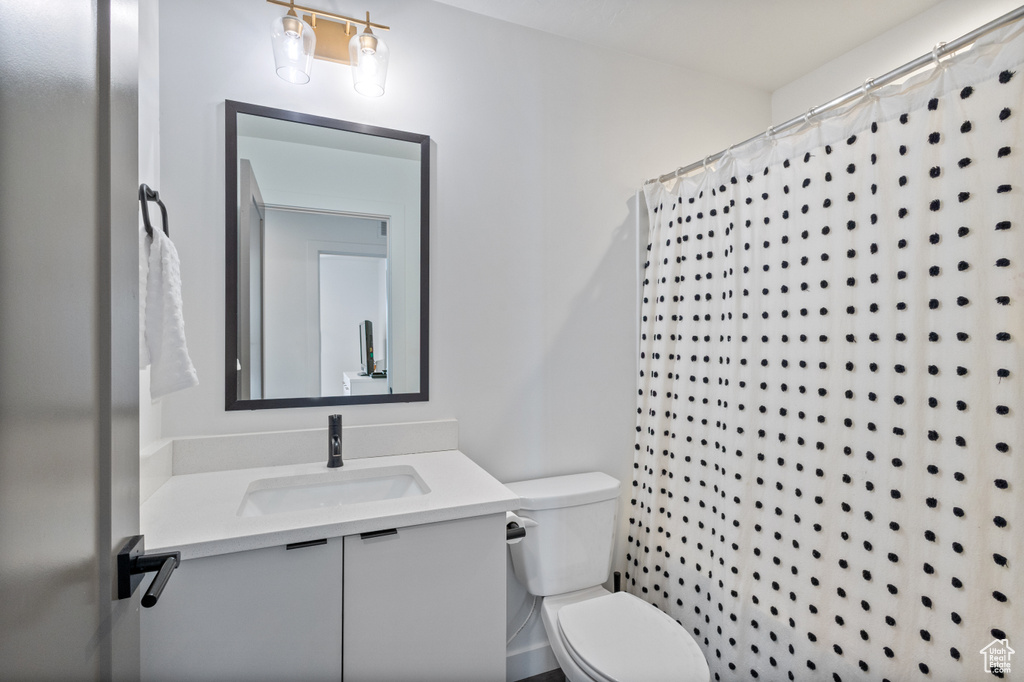 Full bathroom with vanity and curtained shower