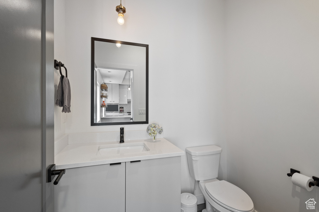 Half bath featuring toilet and vanity