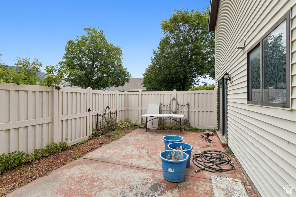 Fenced backyard with a patio