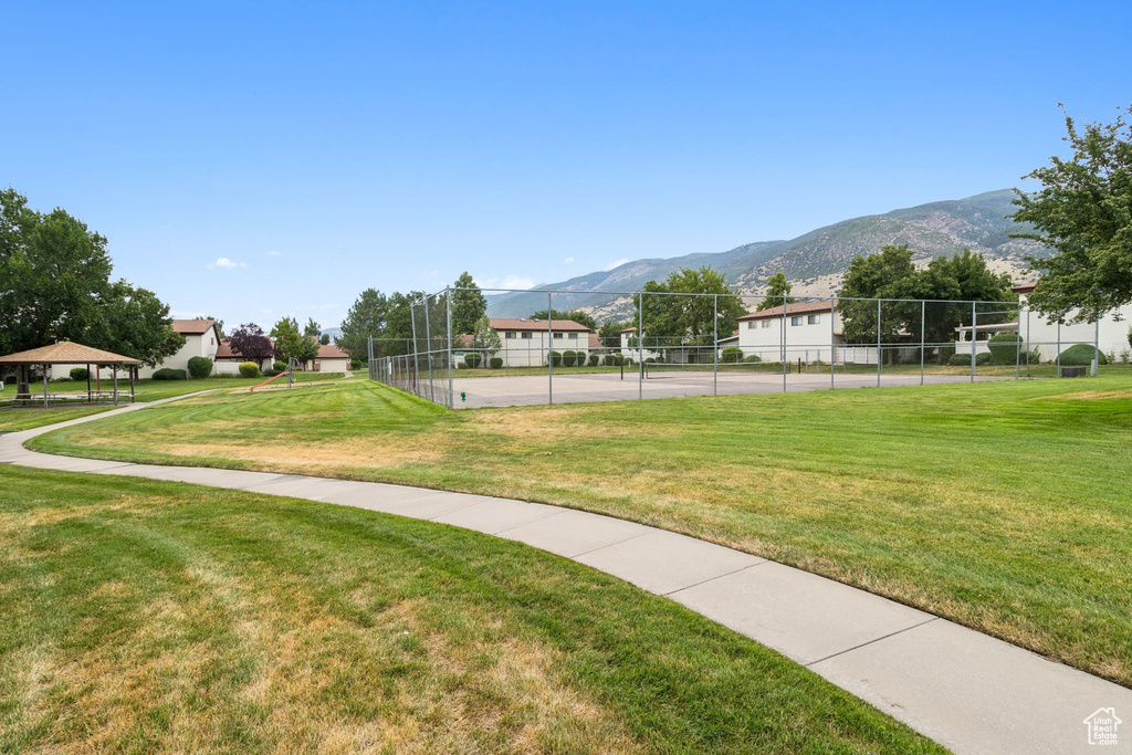 Surrounding community with a gazebo, a tennis court, and a mountain view
