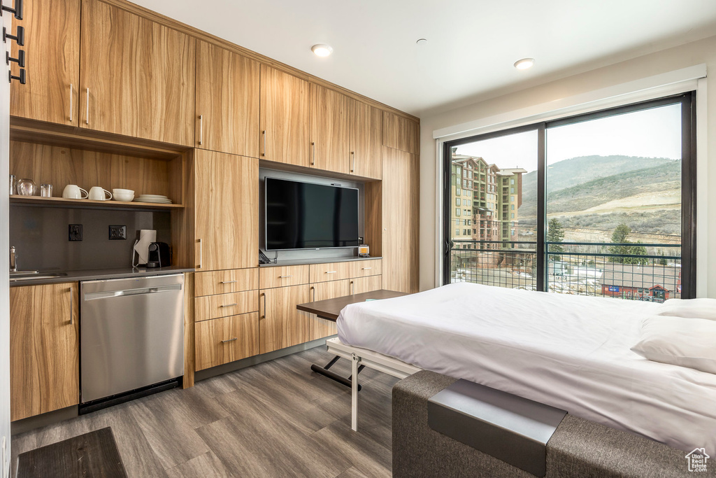 Bedroom with dark wood finished floors and recessed lighting