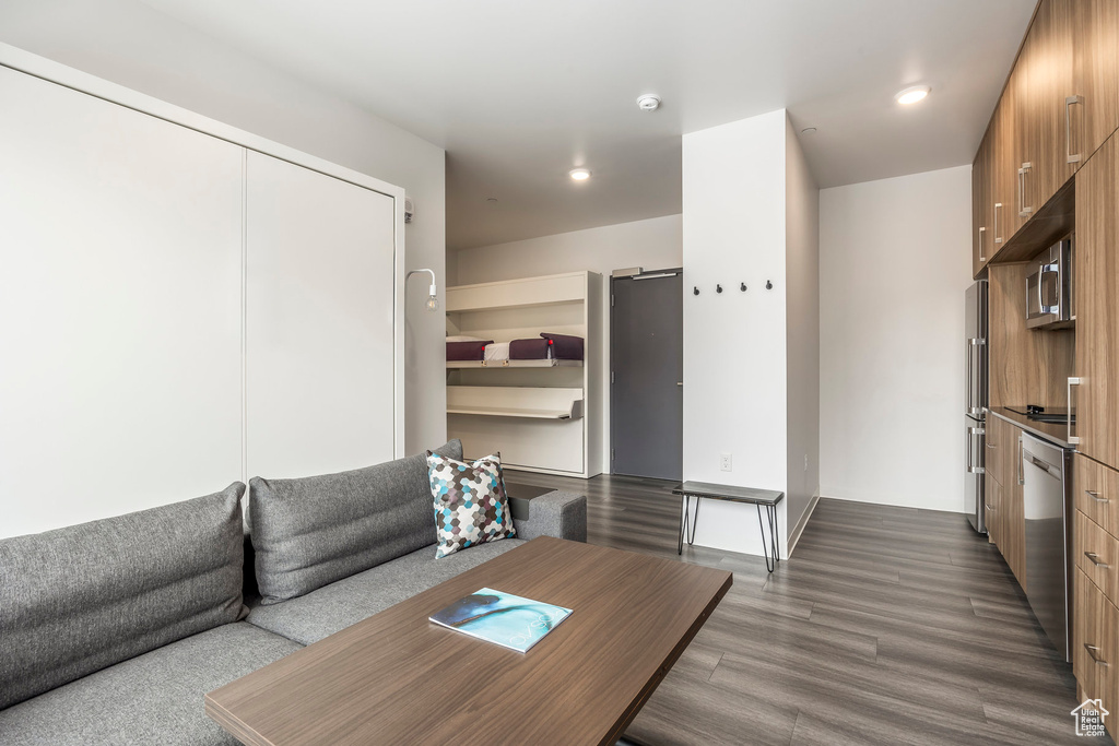 Living area featuring dark wood-style flooring and recessed lighting