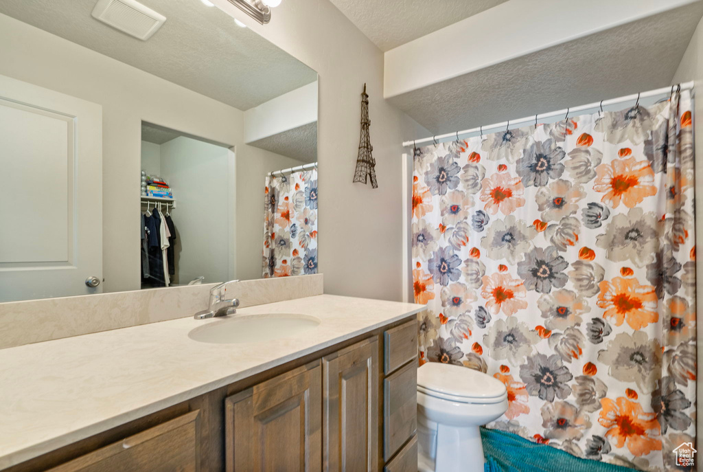 Full bathroom featuring vanity and a shower with shower curtain