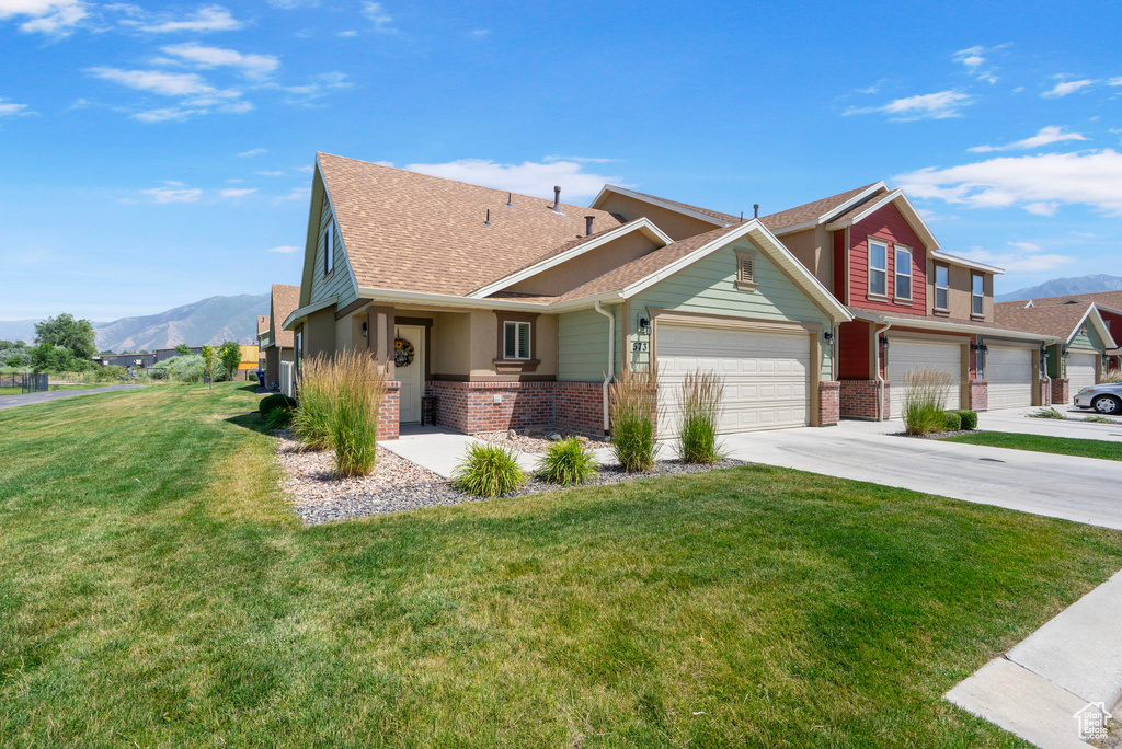 View of front of home featuring a mountain view, brick siding, and a shingled roof