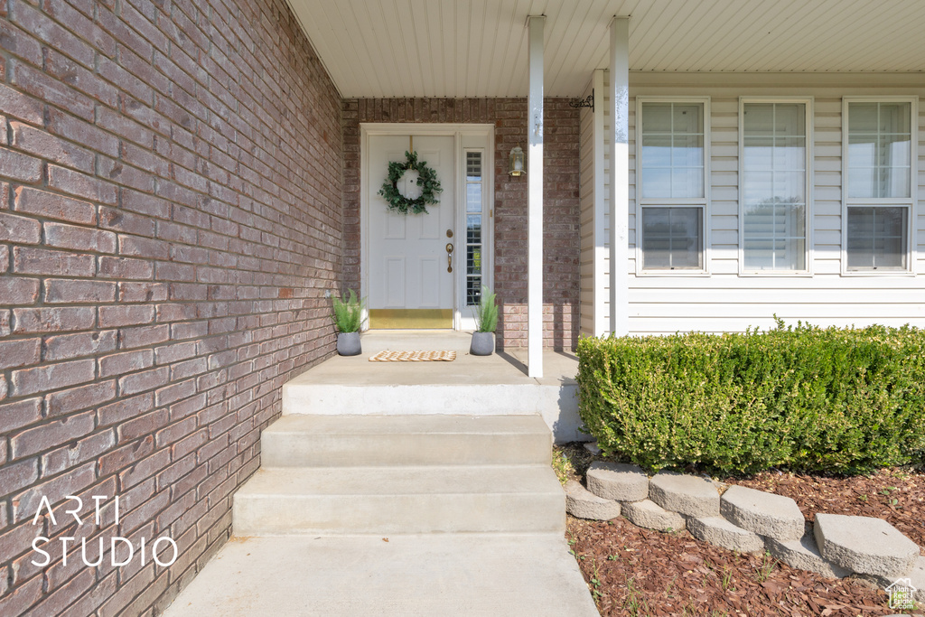 Doorway to property with brick siding