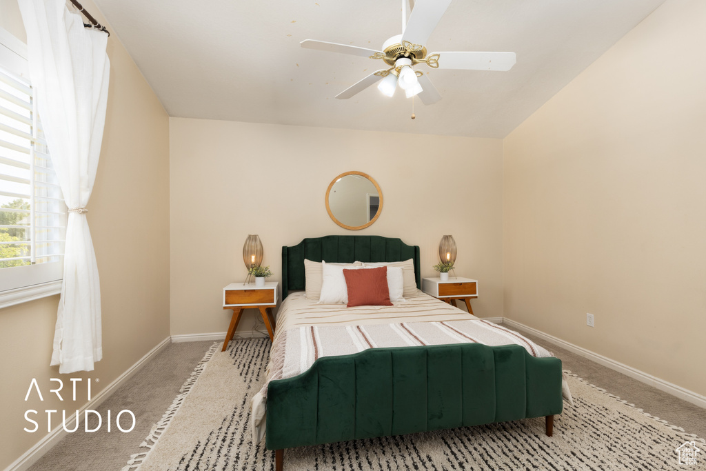 Carpeted bedroom with baseboards and ceiling fan