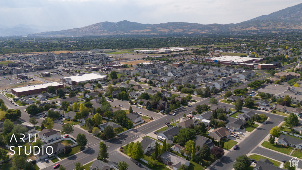 Aerial view of property's location featuring a mountainous background