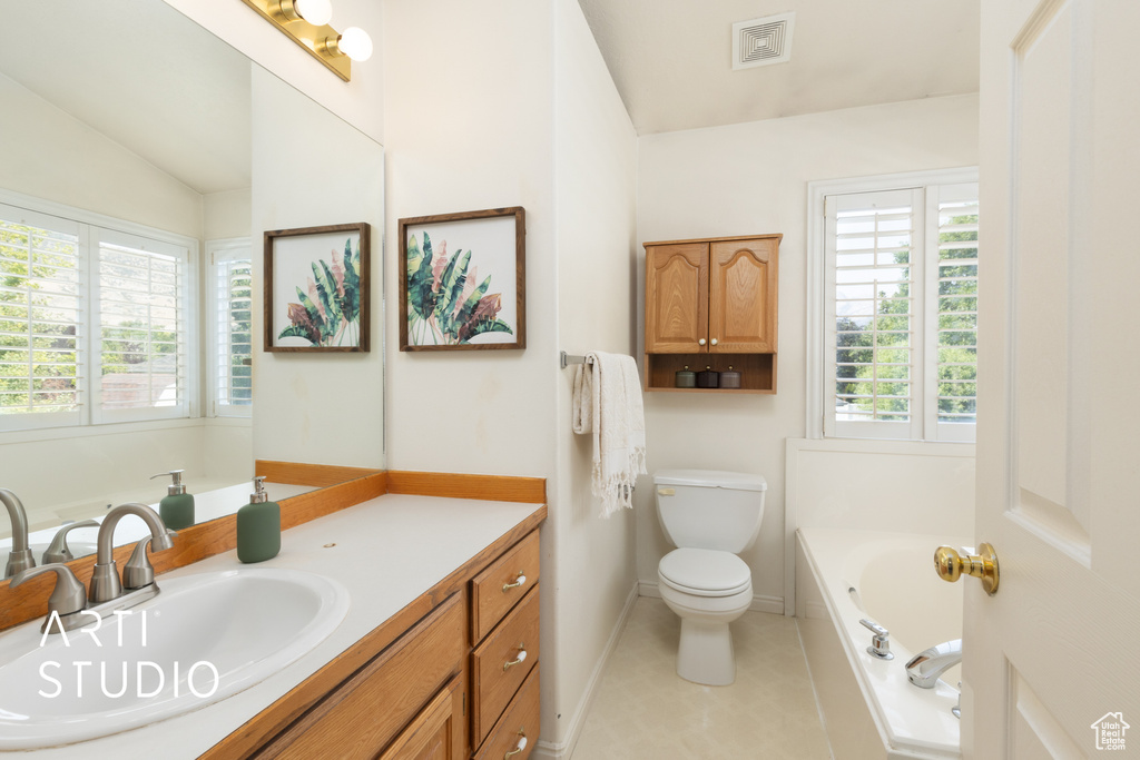 Full bathroom featuring vanity, a bath, vaulted ceiling, and tile patterned floors