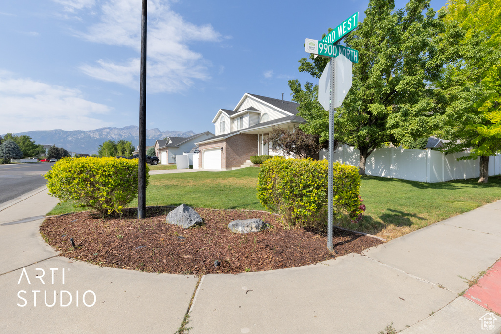 View of front of property with an attached garage and a mountain view