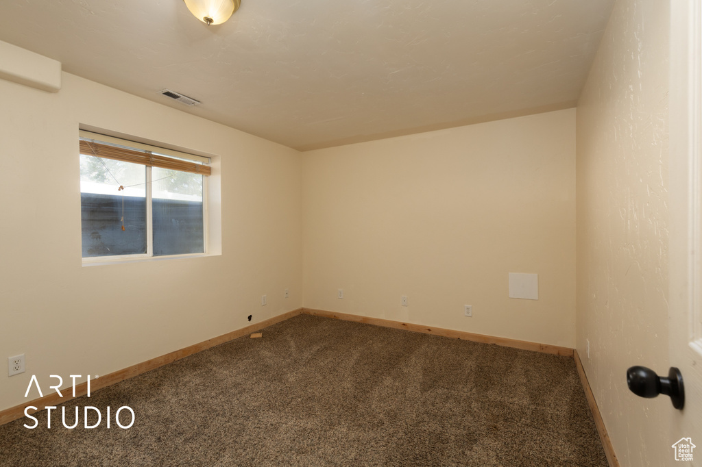Empty room with carpet flooring and baseboards