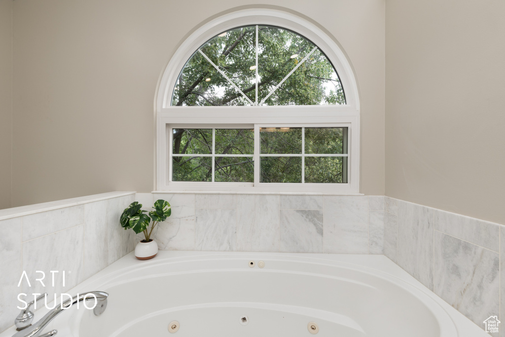 Bathroom with a whirlpool tub and plenty of natural light