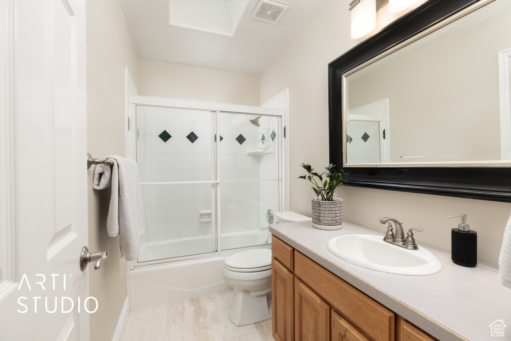 Bathroom with vanity and shower / bath combination with glass door
