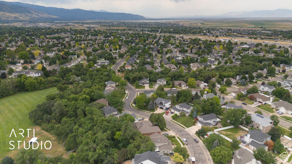 Aerial view of property\\\'s location featuring a mountain backdrop and nearby suburban area