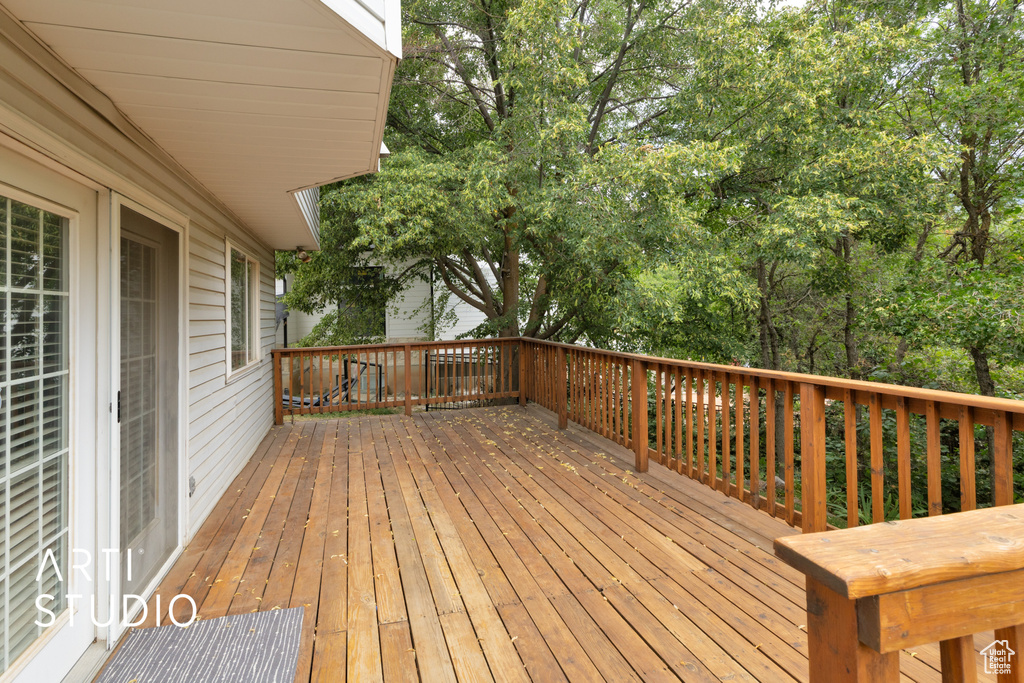 Wooden deck with view of scattered trees
