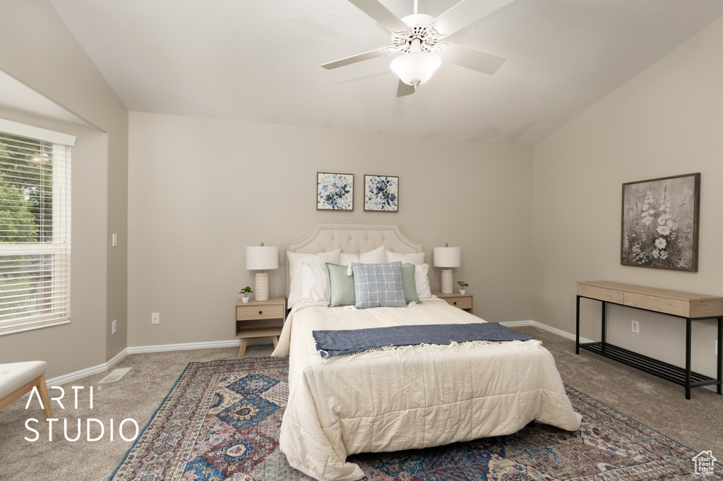 Bedroom with carpet flooring, ceiling fan, and vaulted ceiling