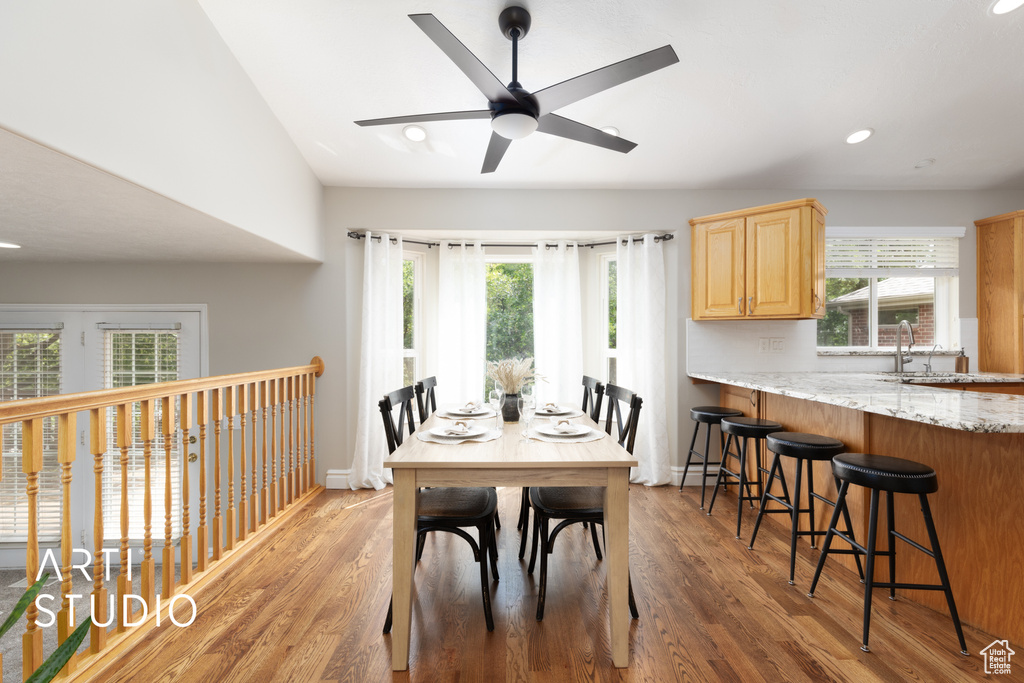 Dining area with light wood-style flooring, ceiling fan, recessed lighting, and lofted ceiling