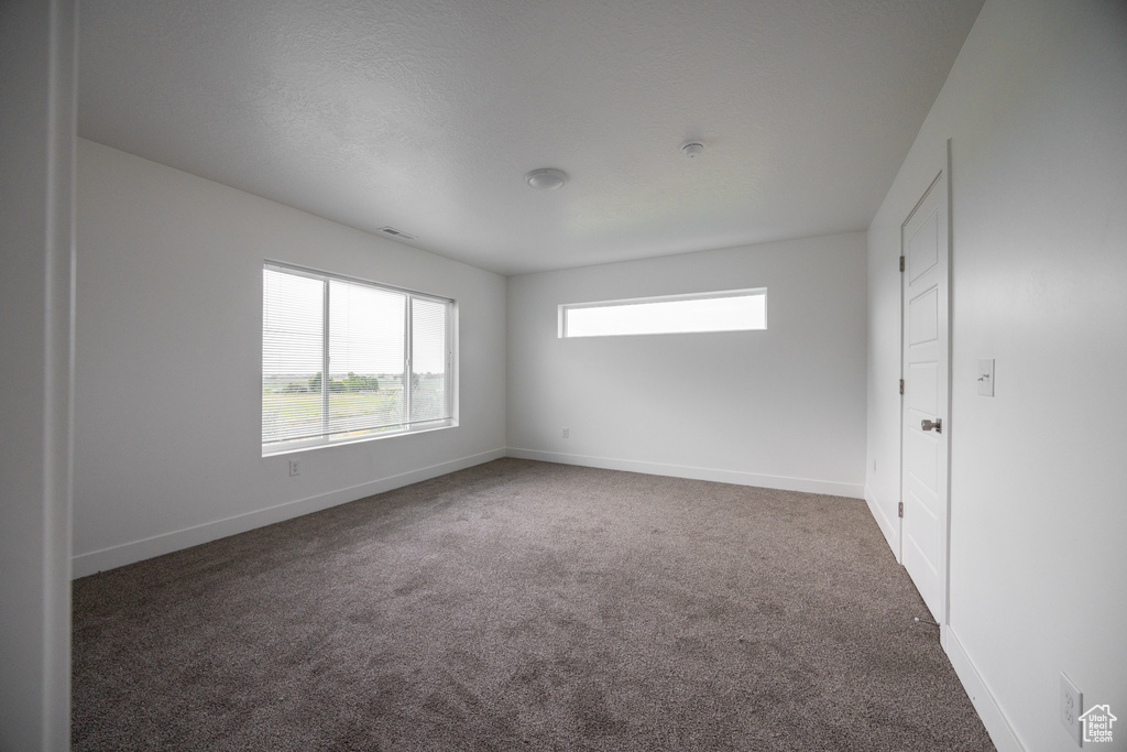 Carpeted empty room with baseboards