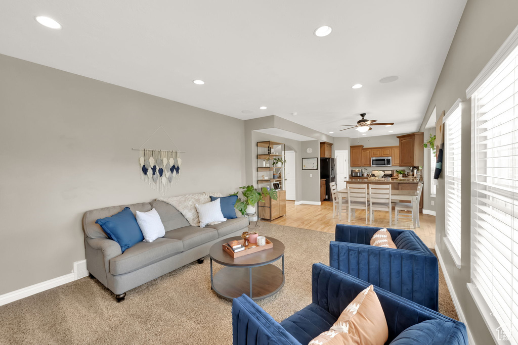 Living area featuring recessed lighting and a ceiling fan