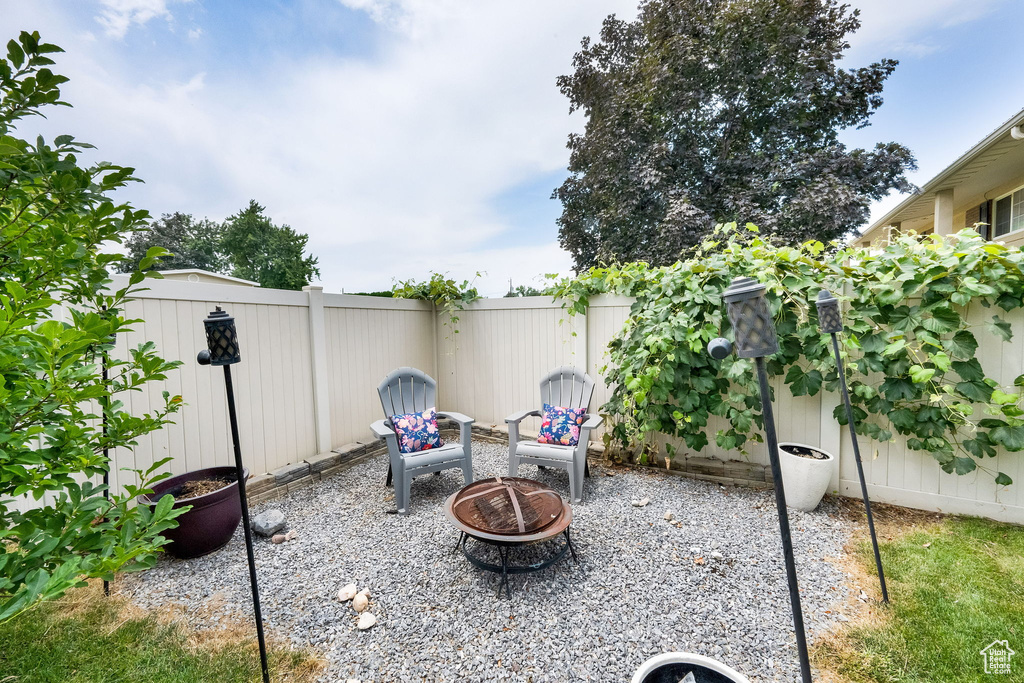 Fenced backyard featuring a fire pit