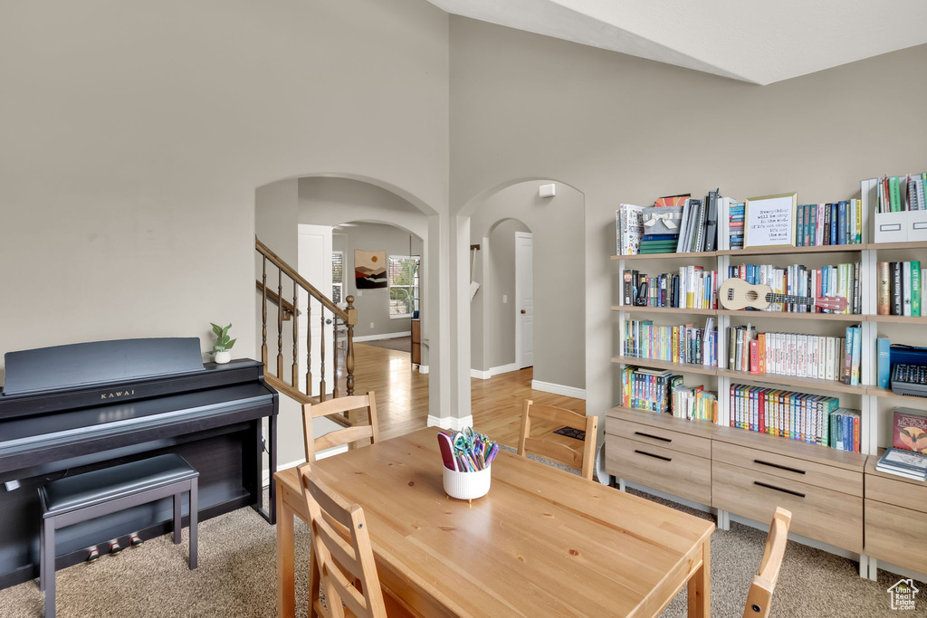Sitting room featuring arched walkways, stairway, and a high ceiling