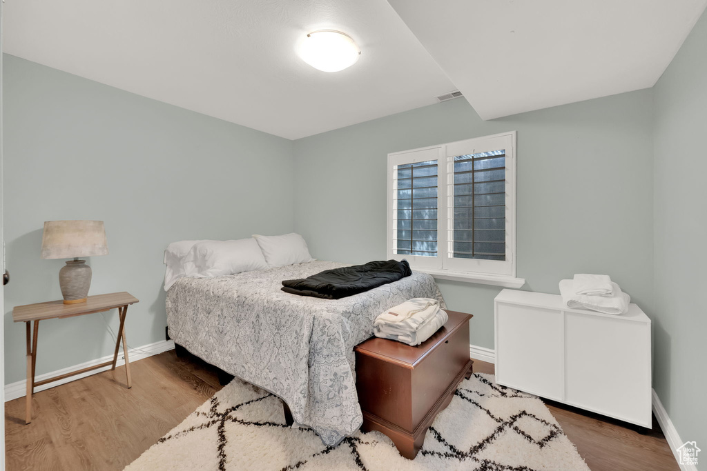 Bedroom featuring baseboards and wood finished floors