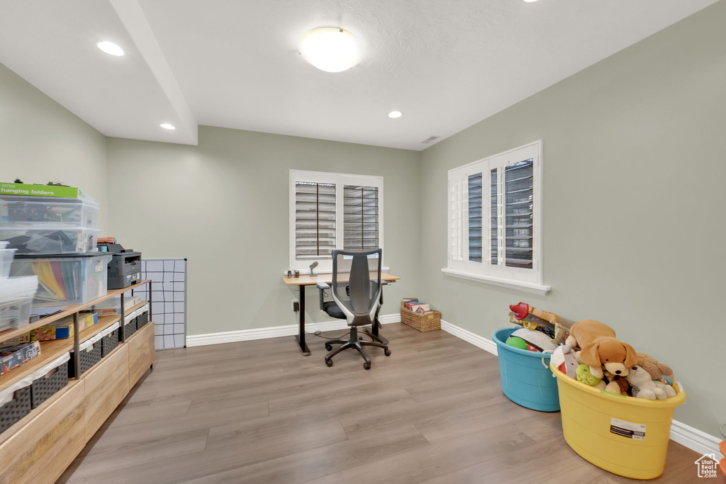 Office space featuring wood finished floors and recessed lighting