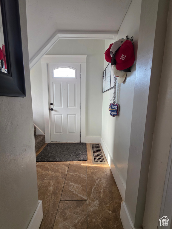 Foyer entrance with lofted ceiling and stairway