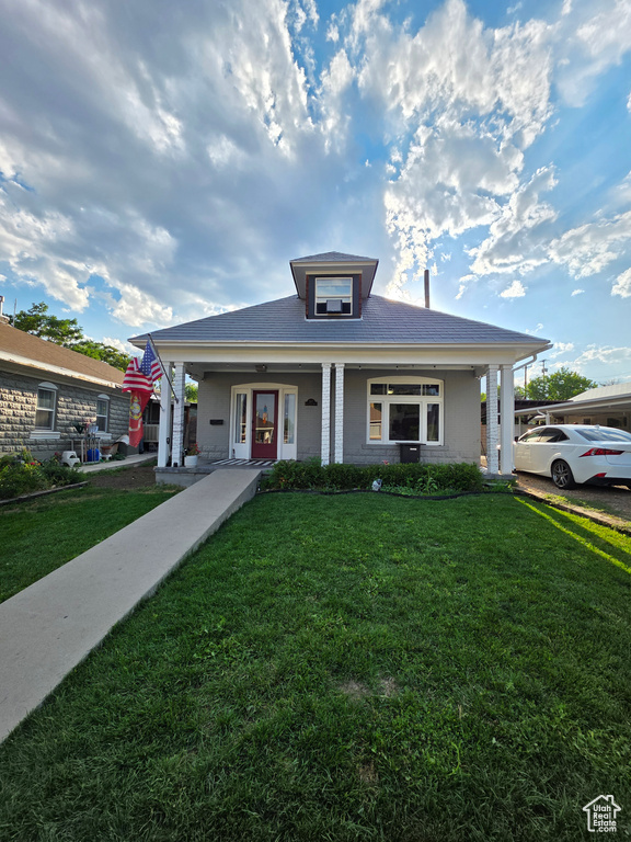 Bungalow featuring a porch and a front yard