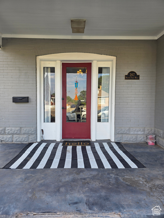 Property entrance featuring brick siding