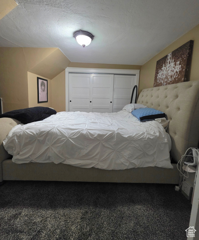 Carpeted bedroom with a closet