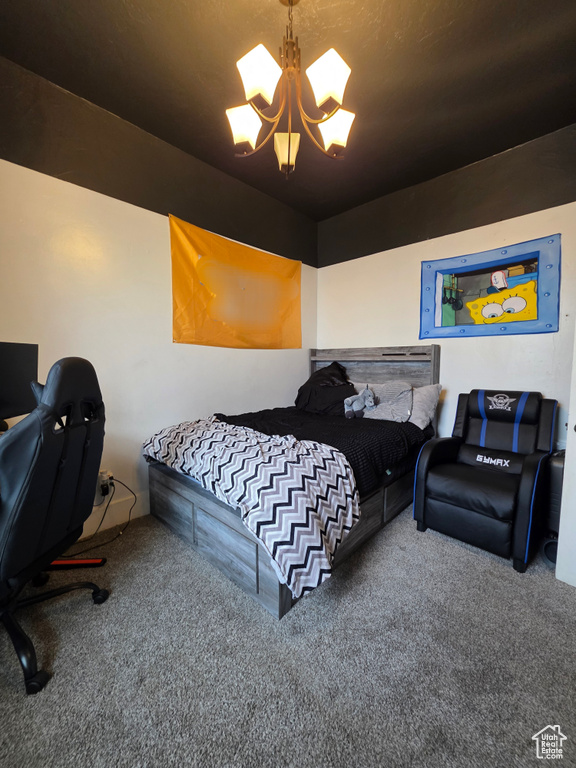 Carpeted bedroom with a chandelier