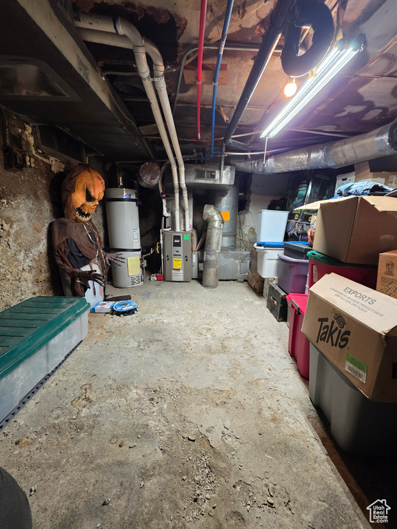 Unfinished below grade area featuring strapped water heater
