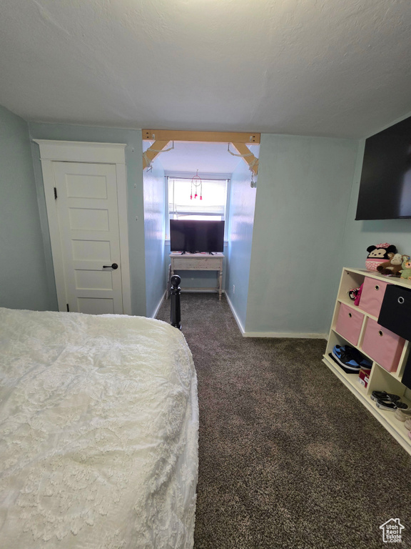 Carpeted bedroom featuring baseboards