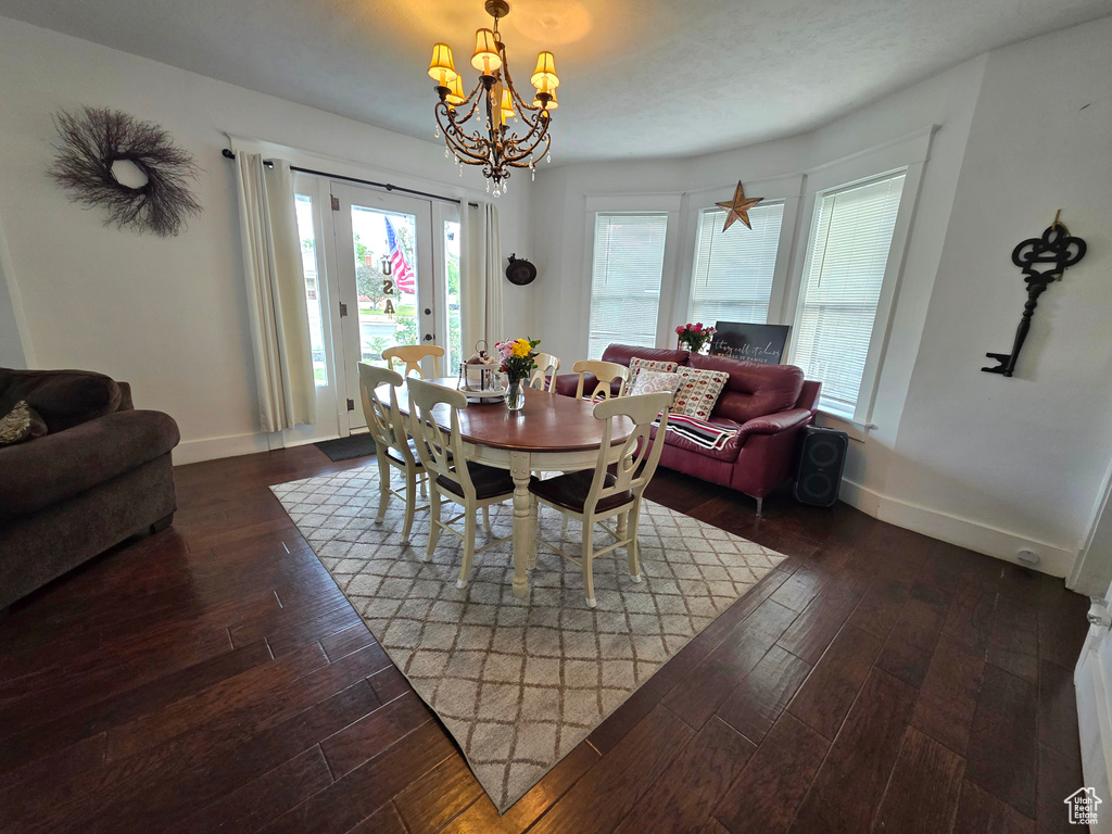 Dining room with a chandelier and hardwood / wood-style floors