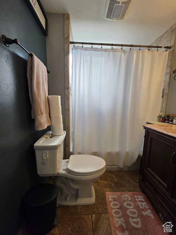 Bathroom featuring stone tile floors and vanity