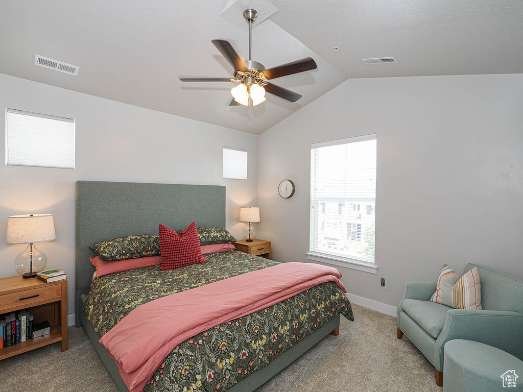 Bedroom with carpet flooring, vaulted ceiling, and ceiling fan