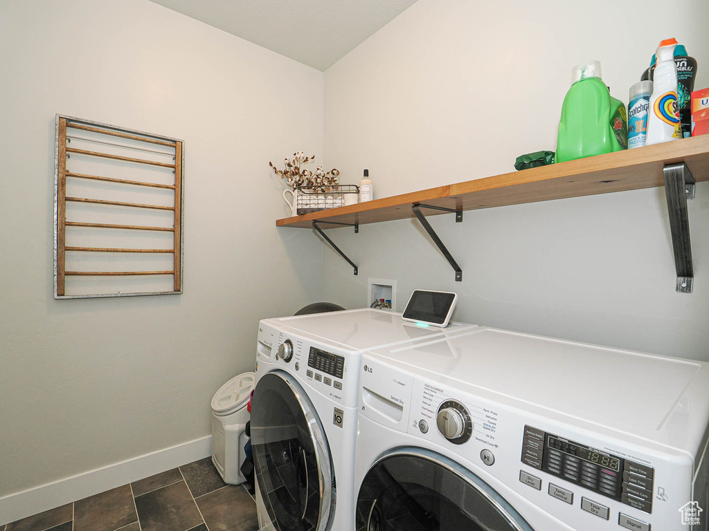 Washroom with washer and clothes dryer and baseboards
