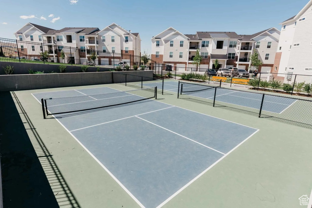 View of tennis court featuring a residential view